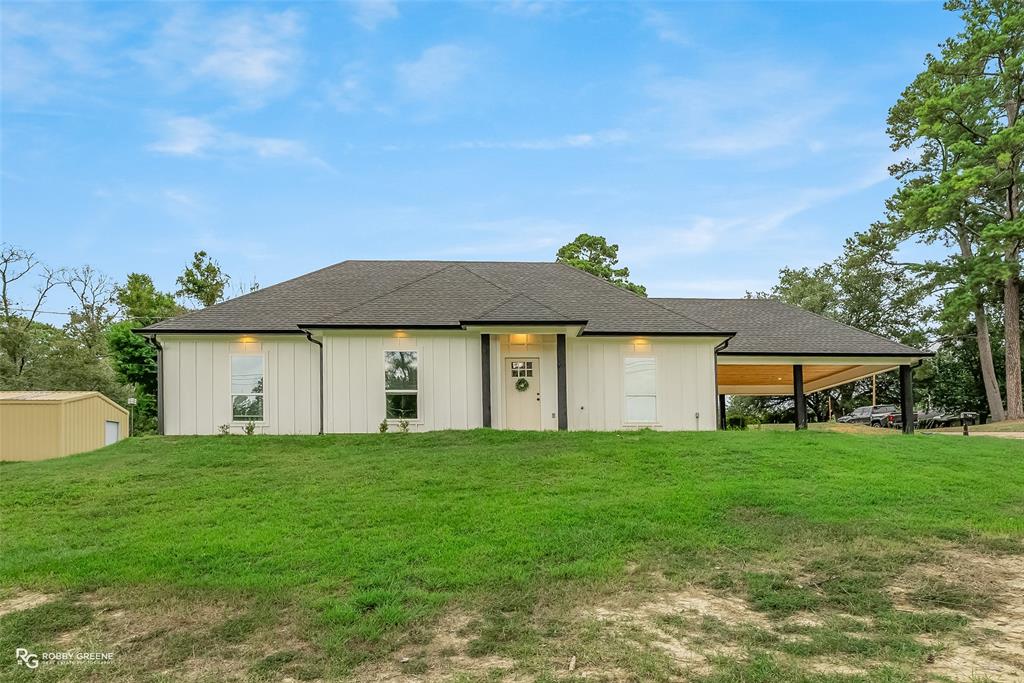 1101 Louisiana Avenue Minden, LA 71055 - Photo 1 of 1 a front view of a house with a yard and garage