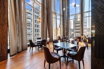 1 Franklin Street, Unit 2406 Boston, MA 02110 - Photo 12 of 22 a view of a dining room with furniture and wooden floor