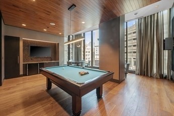 1 Franklin Street, Unit 2406 Boston, MA 02110 - Photo 17 of 22 a view of a room with shelves and wooden floor