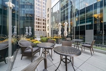 1 Franklin Street, Unit 2406 Boston, MA 02110 - Photo 20 of 22 a view of balcony with a table and chairs