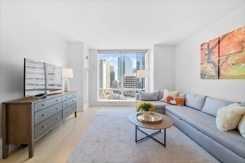 1 Franklin Street, Unit 2406 Boston, MA 02110 - Photo 2 of 22 a living room with furniture and a flat screen tv