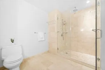 a bathroom with a toilet and a shower