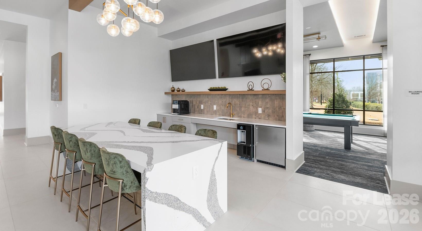 2546 Perimeter Pointe Parkway, Unit 1G Charlotte, NC 28208 - Photo 15 of 48 a kitchen with stainless steel appliances a stove a microwave a sink and cabinets