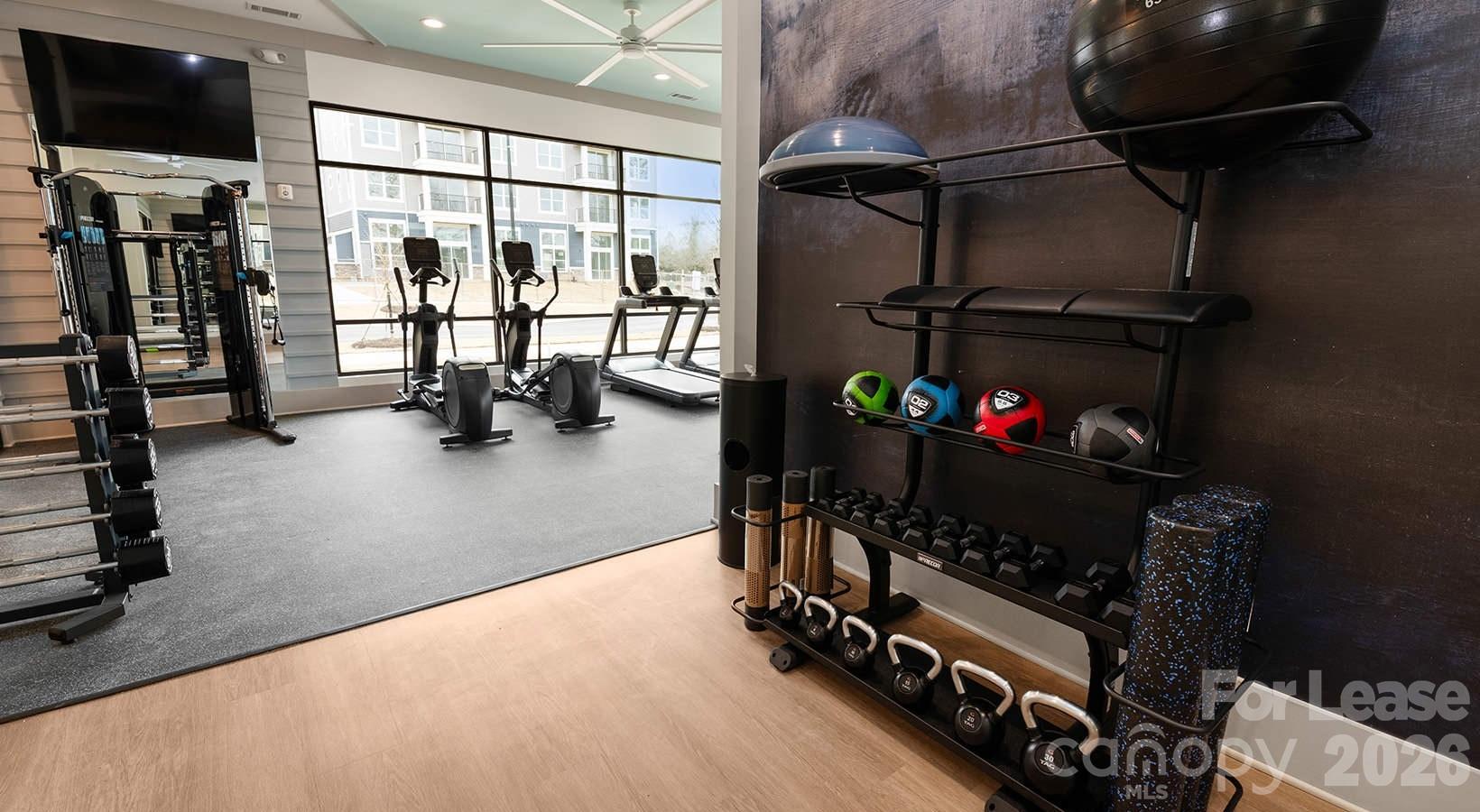 2546 Perimeter Pointe Parkway, Unit 1G Charlotte, NC 28208 - Photo 24 of 48 a room with gym equipment and a large window