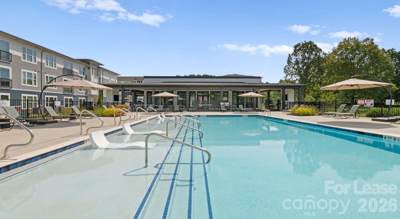 2546 Perimeter Pointe Parkway, Unit 1G Charlotte, NC 28208 - Photo 3 of 48 a view of a swimming pool with a lounge chairs