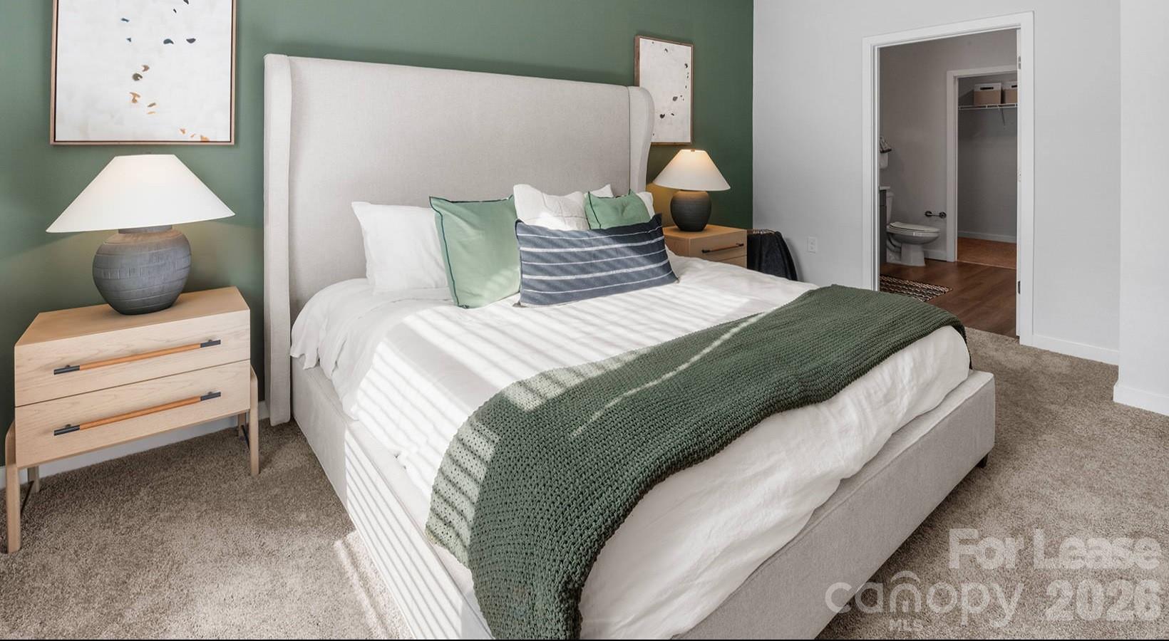 2546 Perimeter Pointe Parkway, Unit 1G Charlotte, NC 28208 - Photo 40 of 48 a bedroom with a bed and wooden floor