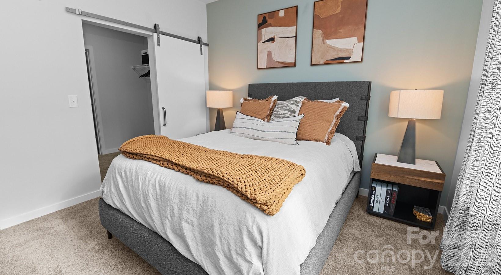 2546 Perimeter Pointe Parkway, Unit 1G Charlotte, NC 28208 - Photo 45 of 48 a bed room with a bed and a night stand