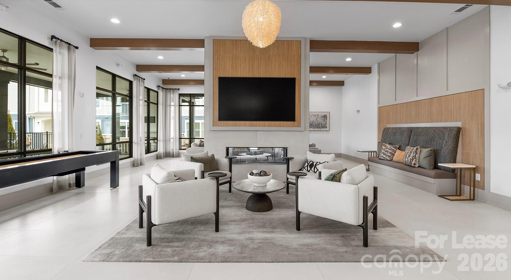 2546 Perimeter Pointe Parkway, Unit 1G Charlotte, NC 28208 - Photo 6 of 48 a living room with furniture and a flat screen tv