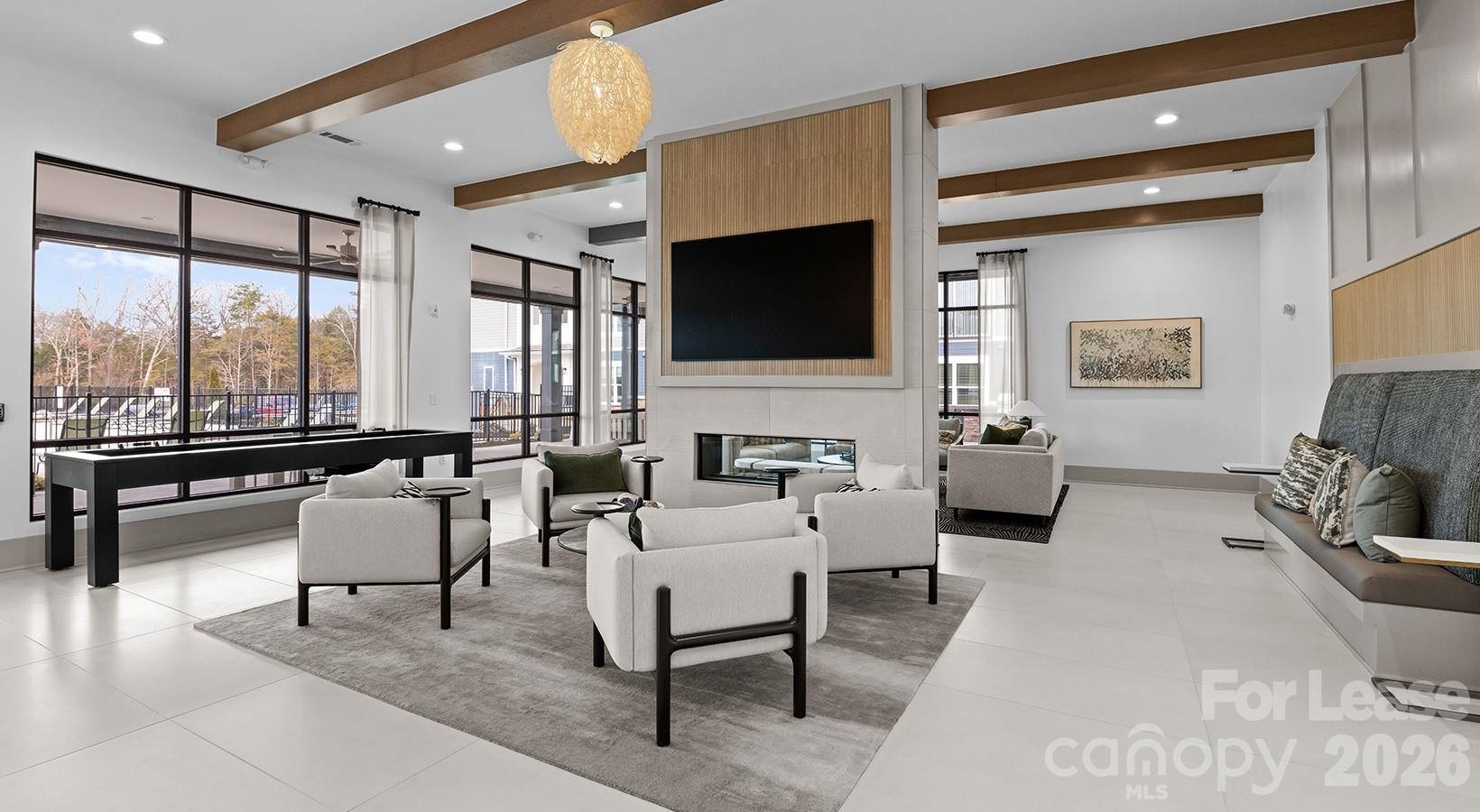 2546 Perimeter Pointe Parkway, Unit 1G Charlotte, NC 28208 - Photo 7 of 48 a living room with furniture and a flat screen tv