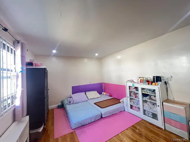 a living room with furniture a flat screen tv and a book shelf