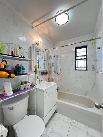 a bathroom with a sink mirror vanity bathtub and a toilet