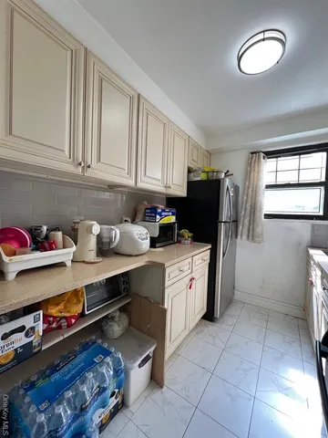 a kitchen with stainless steel appliances granite countertop a refrigerator sink and cabinets