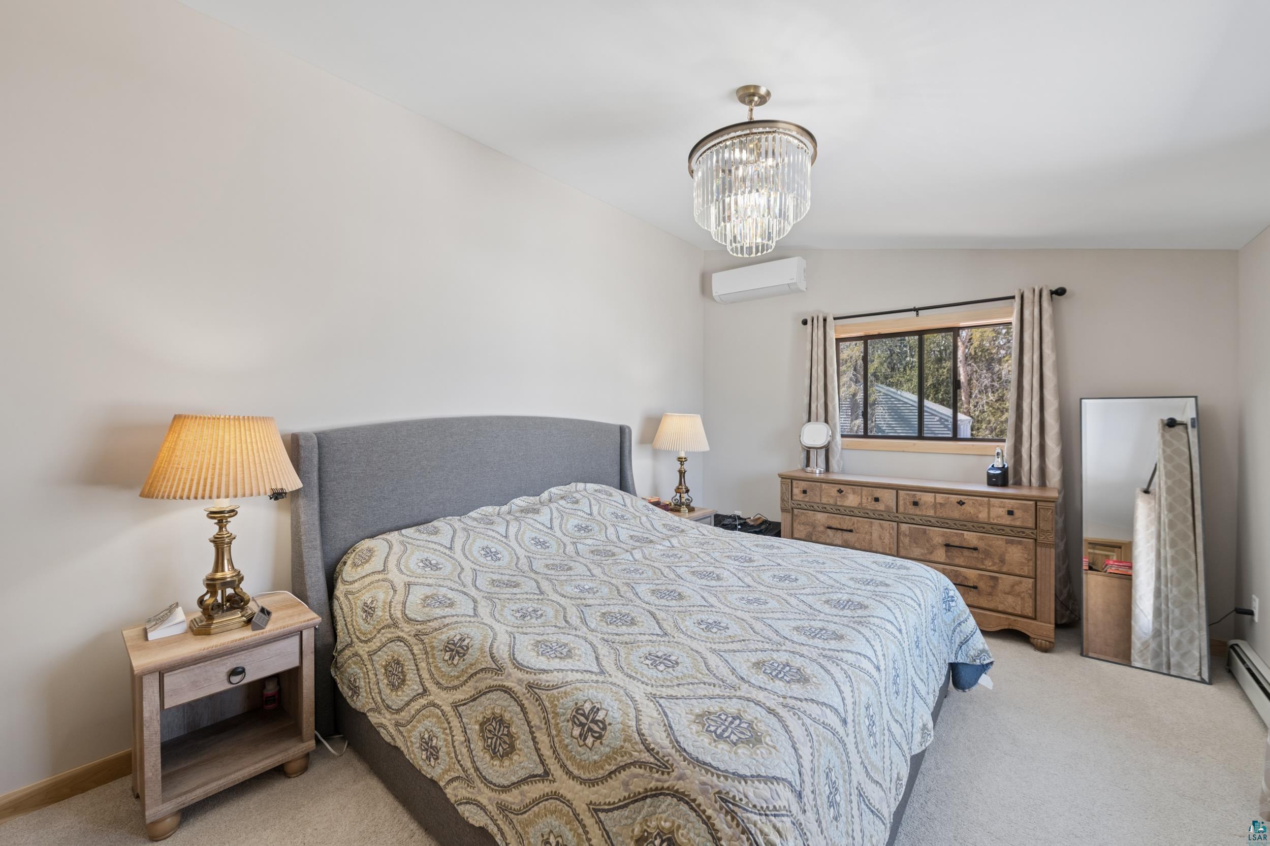 3903 Lake Park Road Ashland, WI 54806 - Photo 21 of 37 Bedroom with light colored carpet, suspended lighting, and lofted ceiling