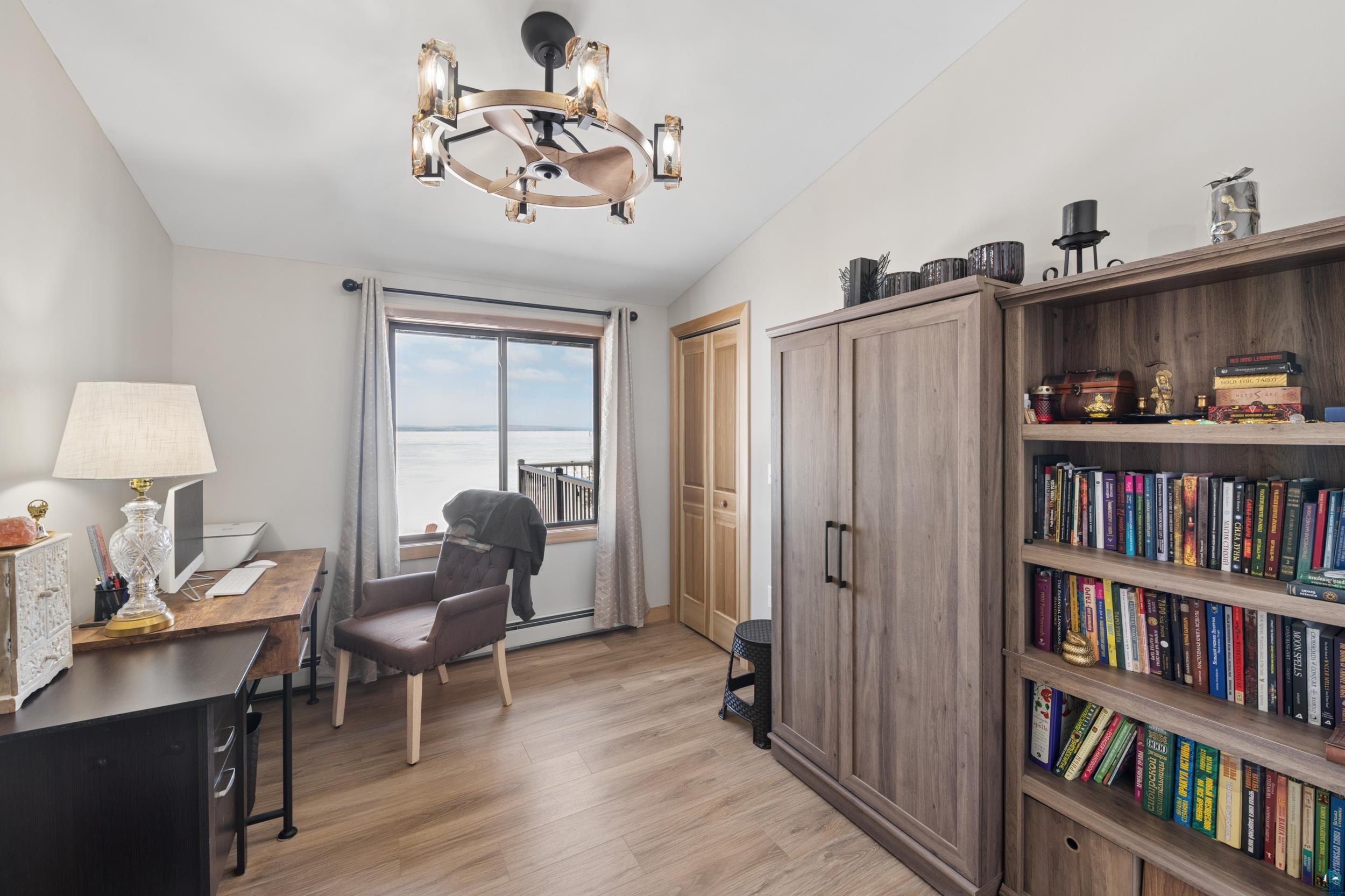 3903 Lake Park Road Ashland, WI 54806 - Photo 22 of 37 Home office with suspended lighting, light wood-style flooring, baseboard heating, and vaulted ceiling