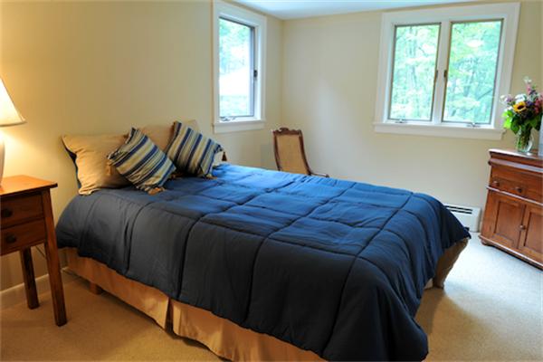 1 Woodland Road Andover, MA 01810 - Photo 19 of 26 a bedroom with a bed and window