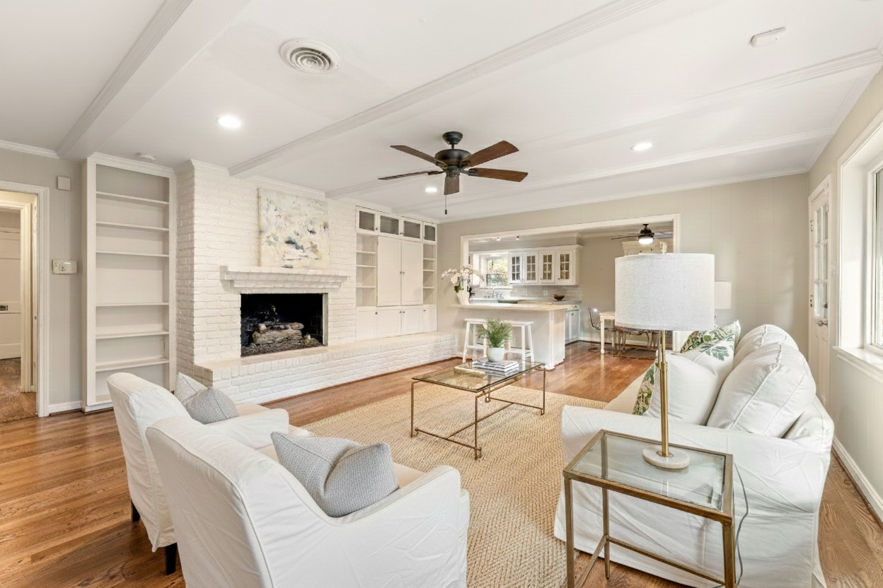 10203 Green Tree Road Houston, TX 77042 - Photo 11 of 28 The inviting family room surrounds a brick fireplace. Enjoy the seamless flow into the kitchen and breakfast room, perfect for entertaining.