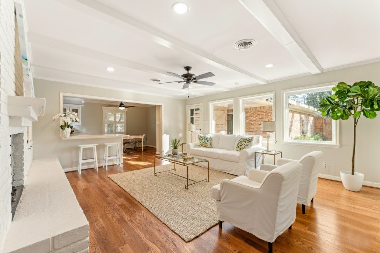 10203 Green Tree Road Houston, TX 77042 - Photo 2 of 28 Family room boasts hardwood floors which continue throughout the home. The rich moldings and beams create a warm and inviting atmosphere.