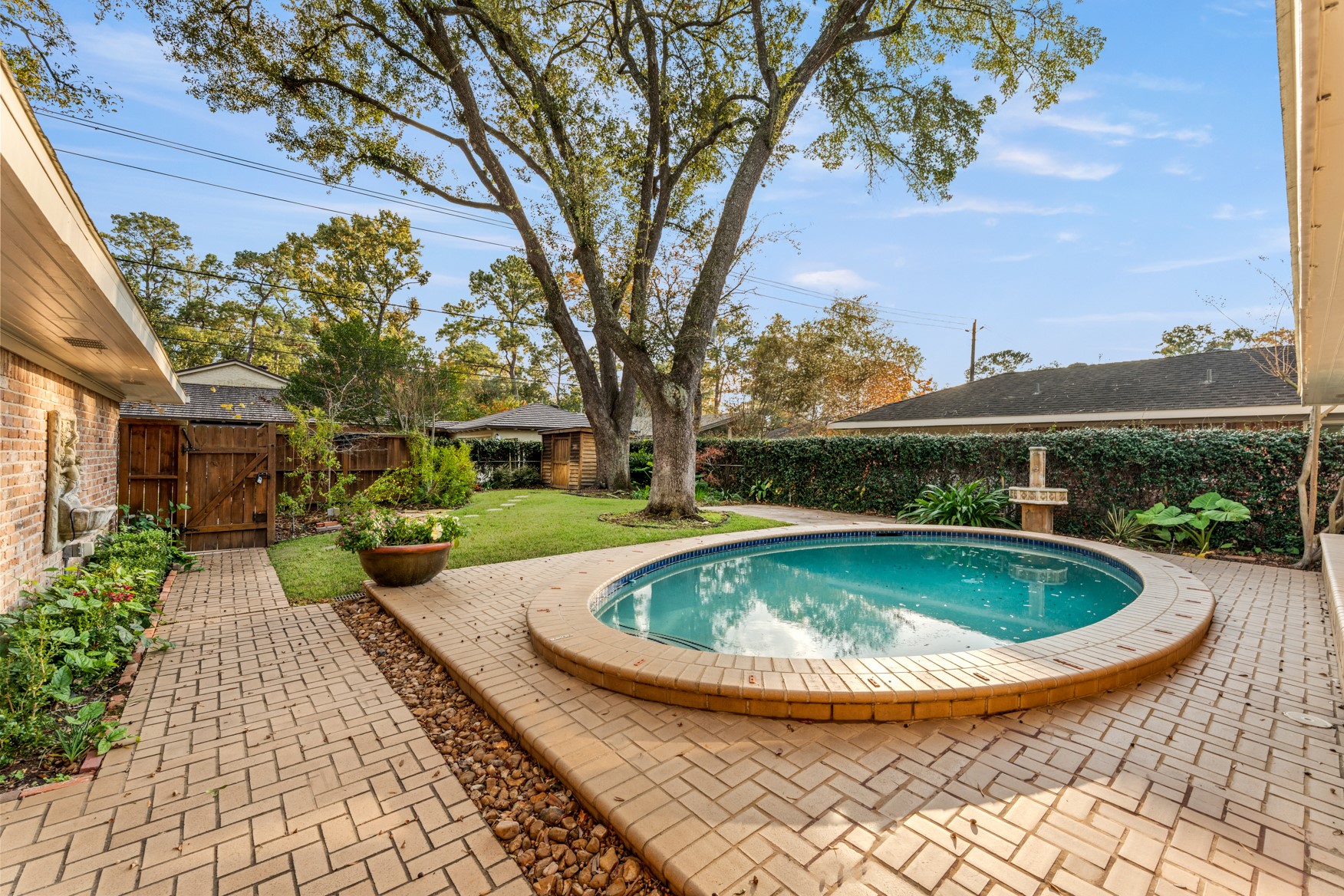 10203 Green Tree Road Houston, TX 77042 - Photo 7 of 28 Incredible backyard boasts abundant green space, covered patio area, and a pool with removable cover.