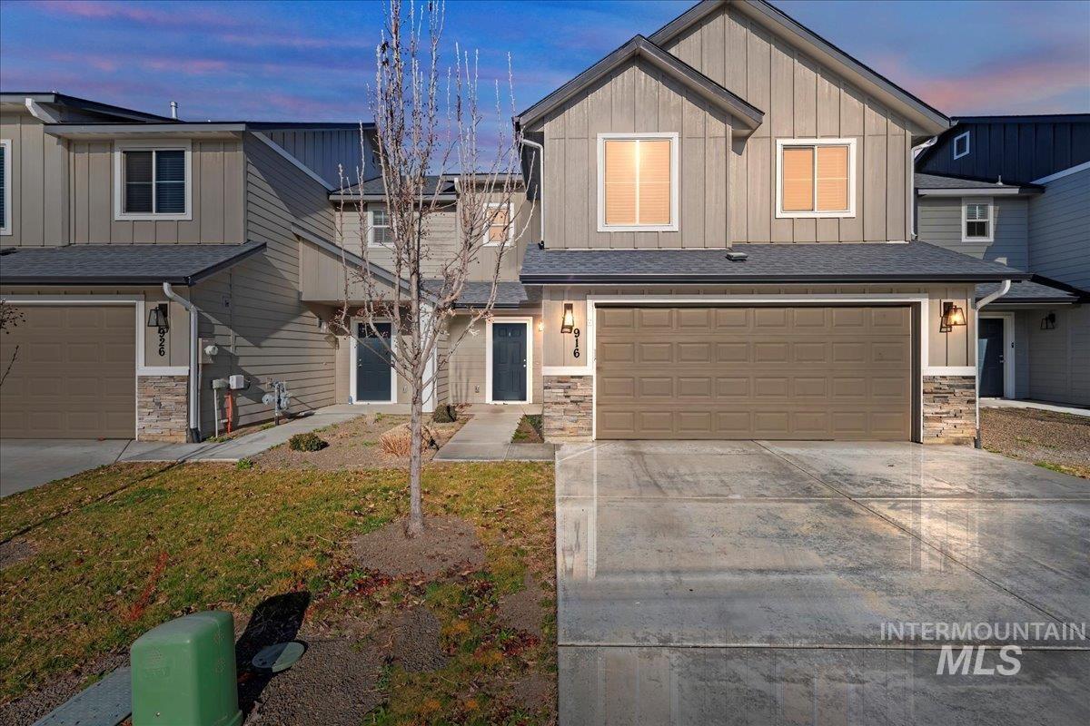 916 West Woodpine Street Meridian, ID 83646 - Photo 1 of 32 Craftsman inspired home with stone siding, board and batten siding, a garage, and driveway