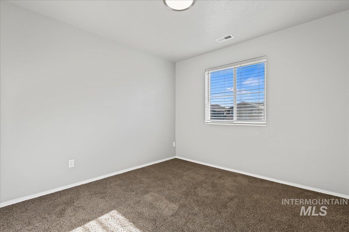 916 West Woodpine Street Meridian, ID 83646 - Photo 19 of 32 Empty room featuring carpet flooring and baseboards