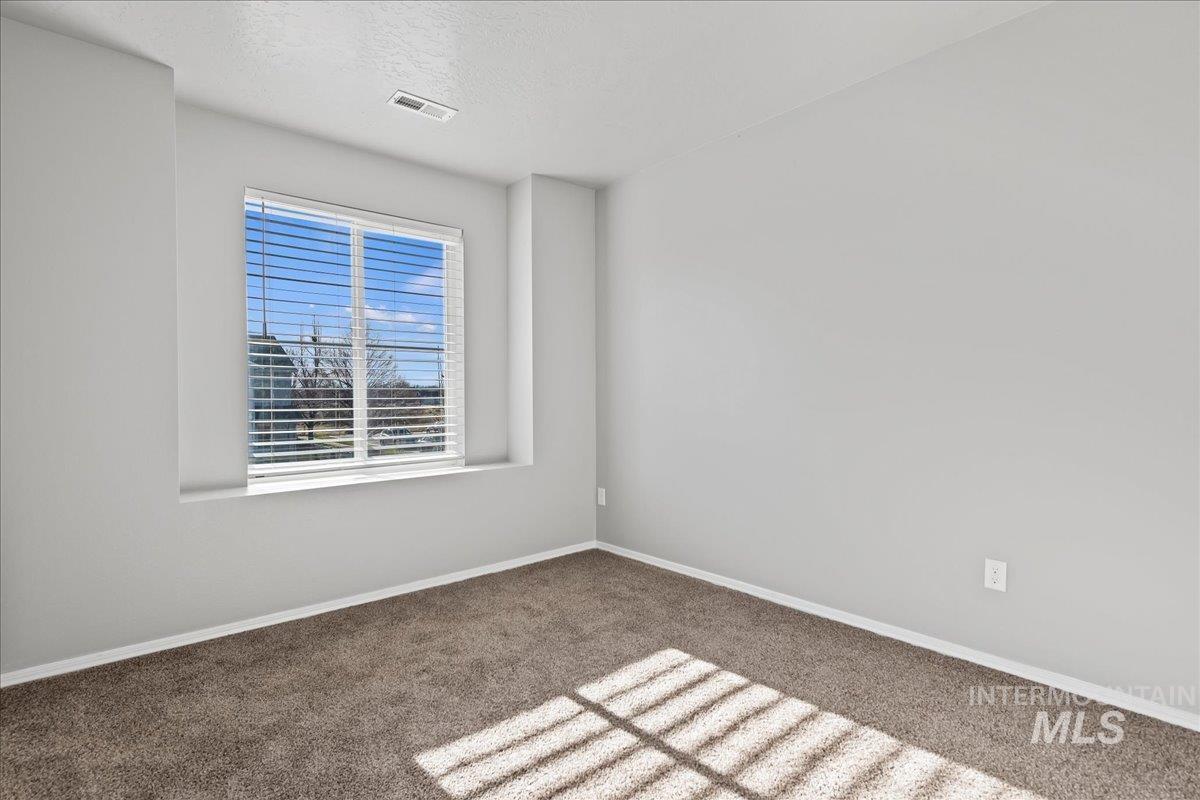 916 West Woodpine Street Meridian, ID 83646 - Photo 20 of 32 Spare room featuring carpet flooring and a textured ceiling