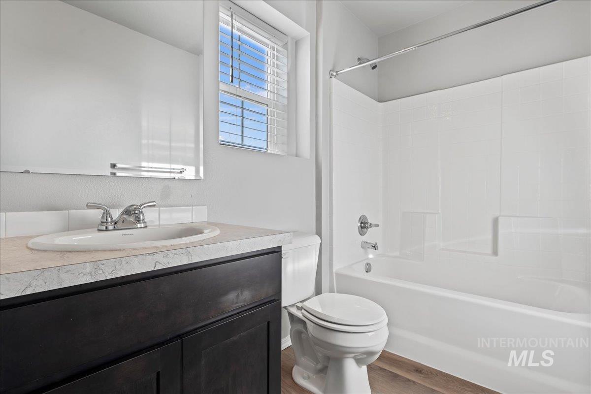 916 West Woodpine Street Meridian, ID 83646 - Photo 24 of 32 Bathroom with vanity, tub / shower combination, and wood finished floors