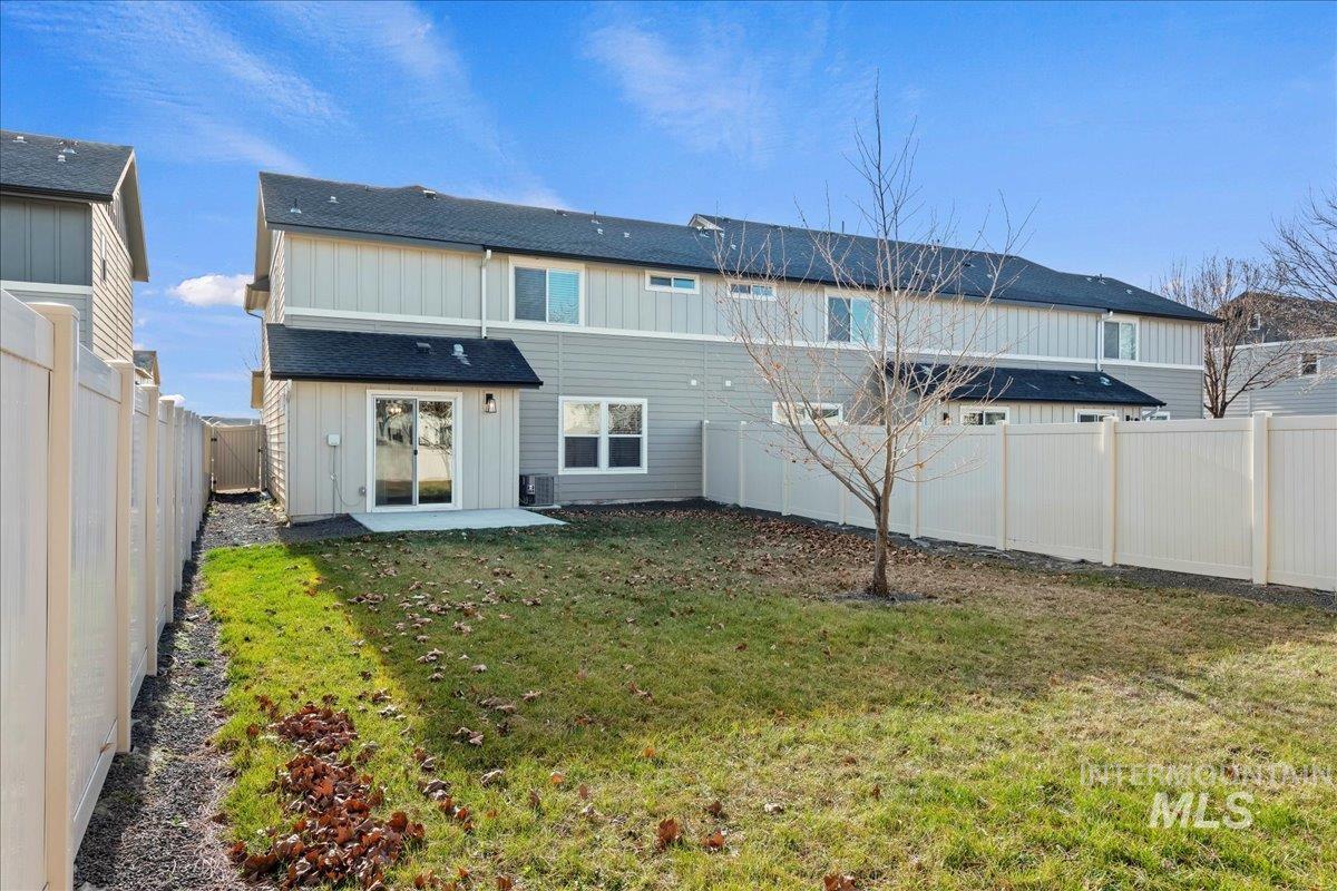 916 West Woodpine Street Meridian, ID 83646 - Photo 28 of 32 Back of property featuring a fenced backyard, a patio area, and board and batten siding