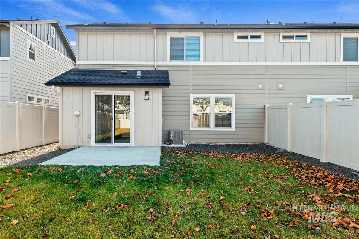 916 West Woodpine Street Meridian, ID 83646 - Photo 29 of 32 Back of house with board and batten siding, a patio, and a fenced backyard