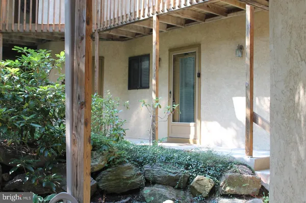a view of a door of the house with potted plants