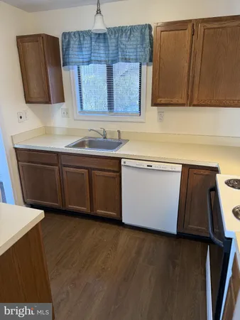 a kitchen with stainless steel appliances wooden cabinets a sink and a stove