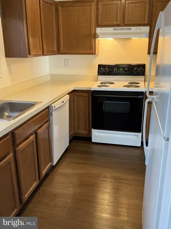 a kitchen with a stove top oven sink and cabinets