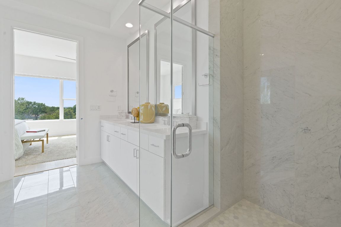 2805 McCurdy Street, Unit 1 Austin, TX 78723 - Photo 18 of 40 a bathroom with a double vanity sink a mirror and a shower