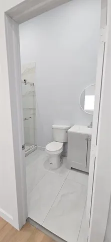a bathroom with a toilet and a shower