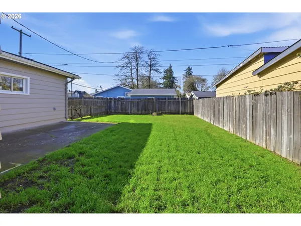 a view of backyard with seating area and green space