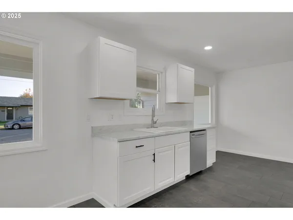 a kitchen with sink and cabinets