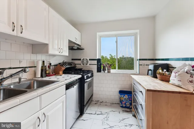 a kitchen with a sink and refrigerator
