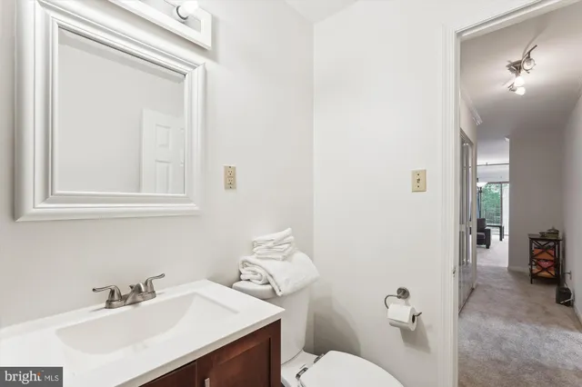 a bathroom with a sink vanity mirror and shower