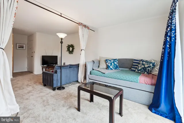 a dining room with furniture a chandelier and wooden floor