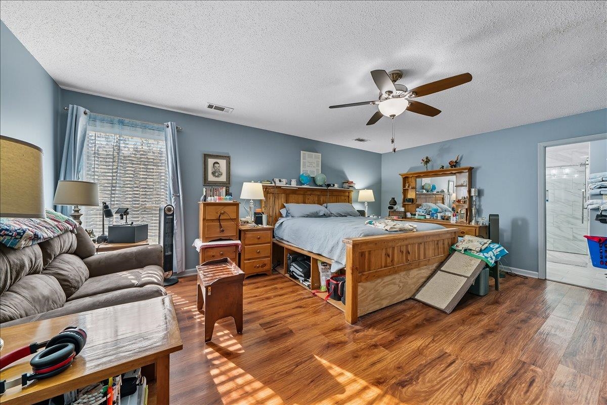6870 Deerfield Road Bartlett, TN 38135 - Photo 12 of 28 Bedroom featuring wood finished floors, a textured ceiling, and a ceiling fan
