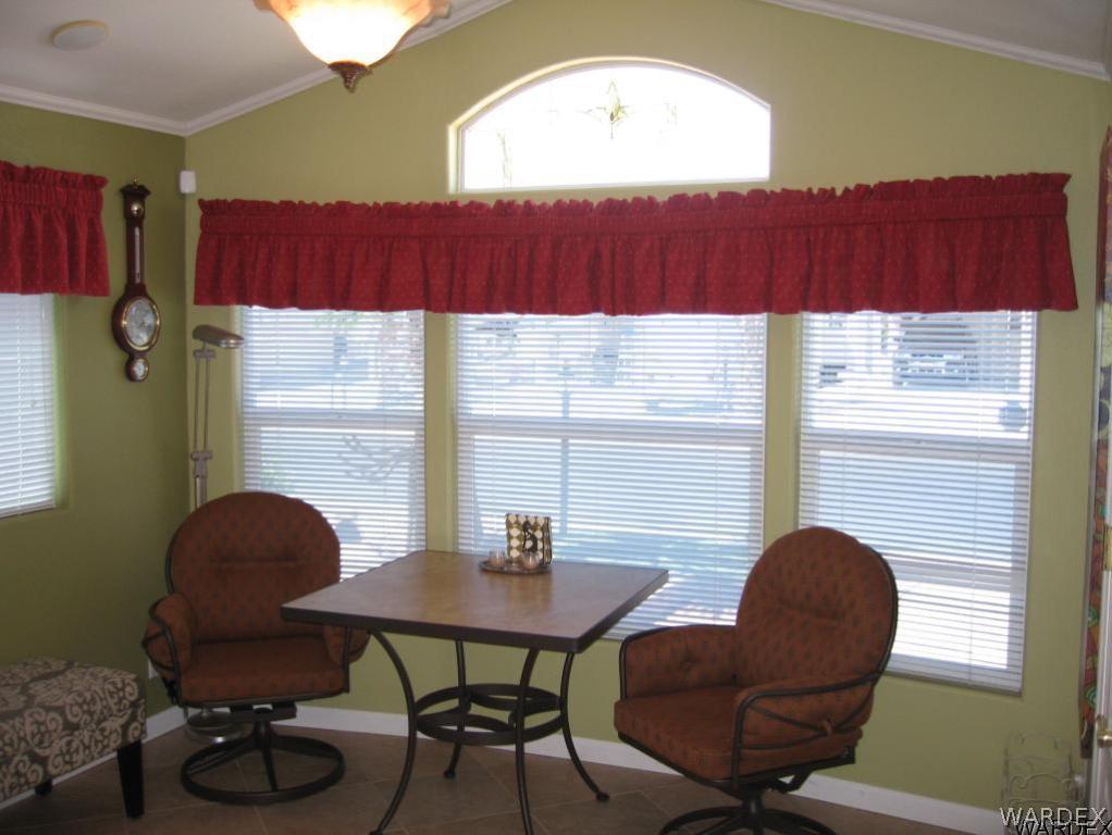 1905 Victoria Farms Road, Unit 83 Lake Havasu City, AZ 86404 - Photo 5 of 30 a view of a dining room with furniture and a window