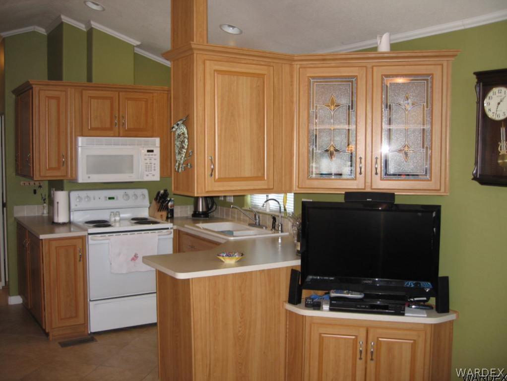 1905 Victoria Farms Road, Unit 83 Lake Havasu City, AZ 86404 - Photo 6 of 30 a kitchen with stainless steel appliances a stove a sink and a microwave