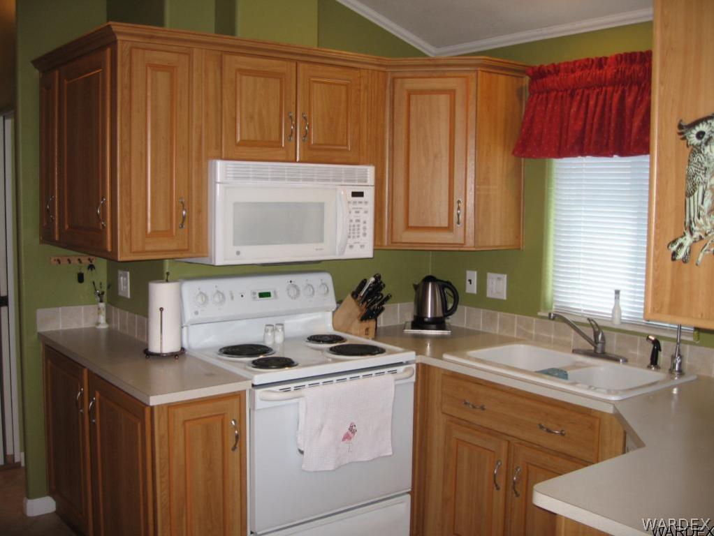 1905 Victoria Farms Road, Unit 83 Lake Havasu City, AZ 86404 - Photo 7 of 30 a kitchen with a sink cabinets and window
