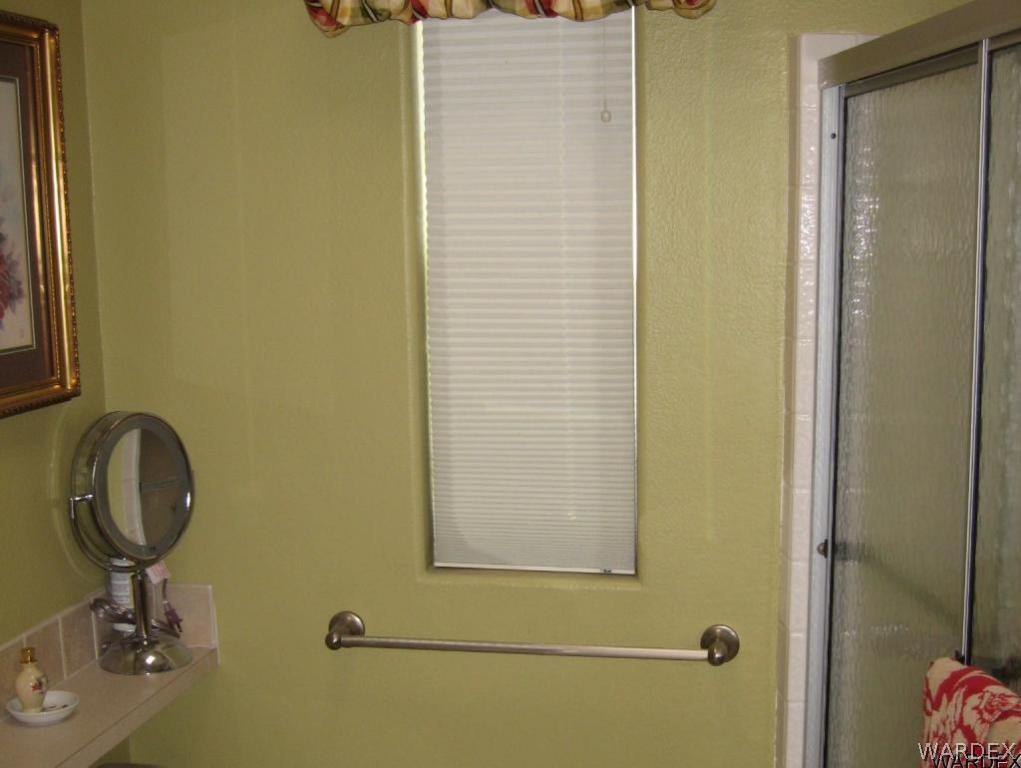 1905 Victoria Farms Road, Unit 83 Lake Havasu City, AZ 86404 - Photo 10 of 30 a bathroom with a granite countertop sink and a mirror