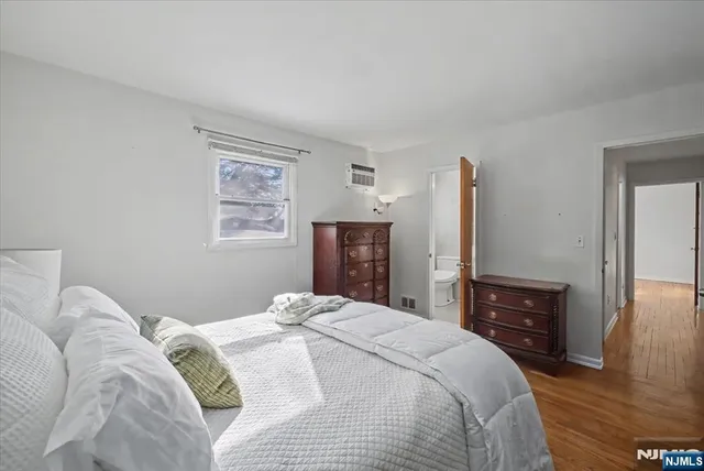a bedroom with a bed and a tv on table