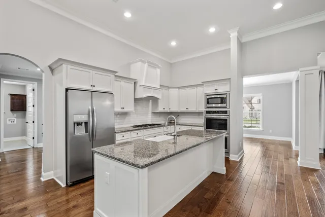 a large kitchen with granite countertop a stove and a sink