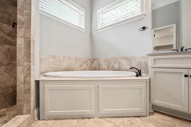 a bathroom with a bathtub and shower