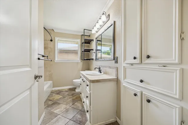 a bathroom with a sink toilet and mirror