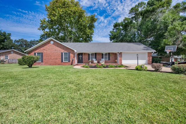 a front view of house with yard and green space