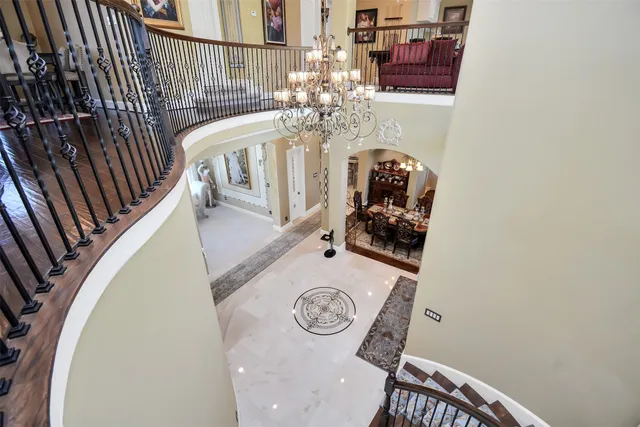 a view of a dining room with furniture a chandelier and wooden floor