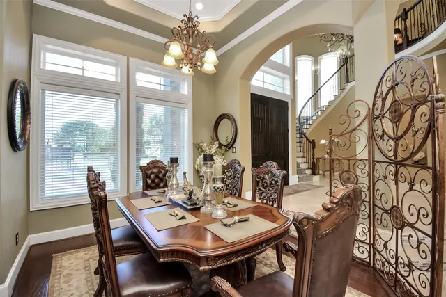 a view of a dining room with furniture and chandelier